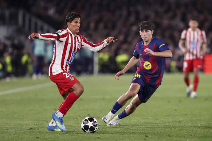 El jugador del Atlético de Madrid Giuliano Simeone disputa un balón con el del FC Barcelona Fermín López en la ida de cuartos de final de la Liga de Campeones 2025-2026.