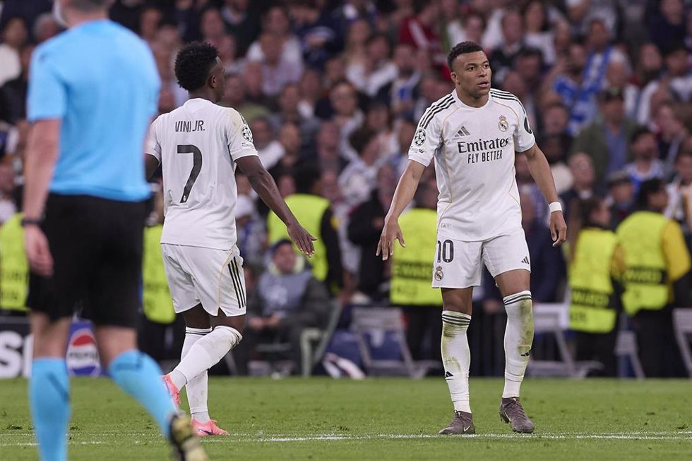El delantero brasileño Vinícius Júnior (izq) y el francés Kylian Mbappé (dcha) chocan la mano en el partido entre el Real Madrid CF y el Bayern de Múnich de la Champions 2025-26 en el Santiago Bernabéu.