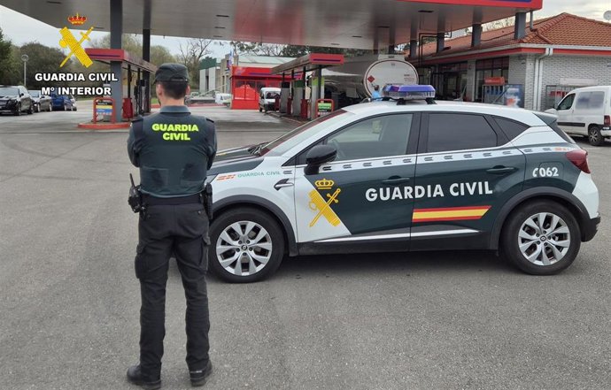 Archivo - Agente y coche de la Guardia Civil
