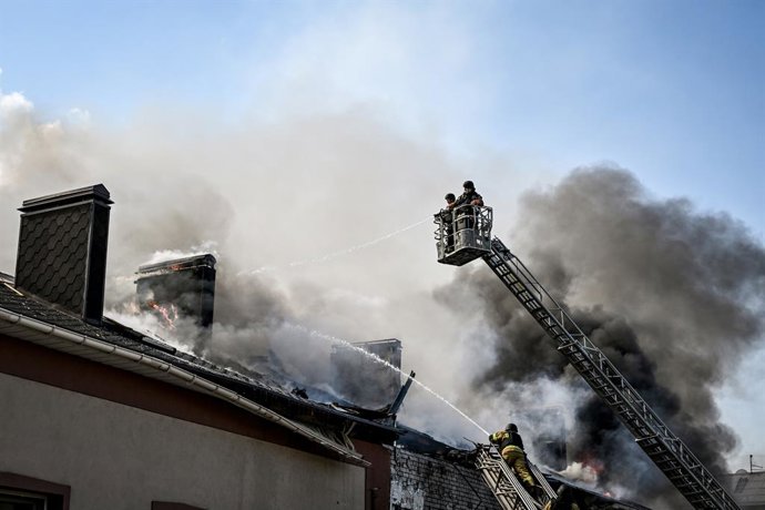 April 13, 2026, Zaporizhzhia, Ukraine: Rescuers use a telescopic ladder and an aerial work platform to extinguish a fire in an office building caused by a Russian drone strike in Zaporizhzhia, Ukraine, April 13, 2026. The Russian attack also damaged indus