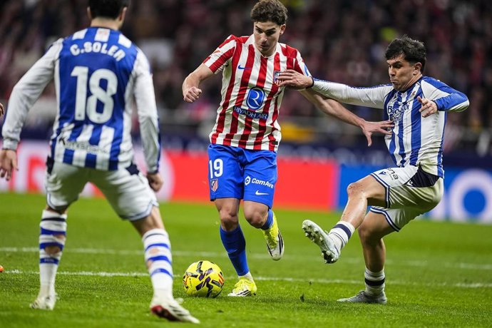 Archivo - El delantero del Atlético de Madrid Julián Álvarez disputa un balón en un partido de LaLiga EA Sports ante los de la Real Sociedad Pablo Marín y Carlos Soler.