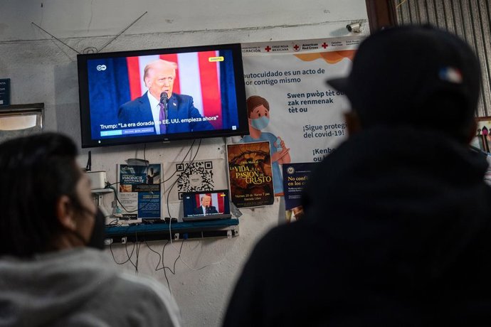 Archivo - 20 January 2025, Mexico, Tijuana: Latin American migrants watch the inauguration of US President Donald Trump at the Juventud 2000 shelter in Tijuana. Migrants knew that an app used to pre-schedule appointments and dates to apply for asylum in t