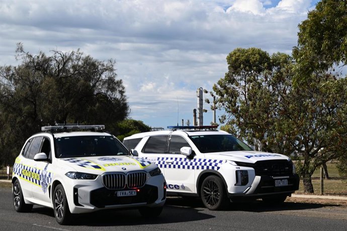 MELBOURNE, April 16, 2026  -- Two police cars are seen outside Viva Energy's refinery in Geelong, Australia, April 16, 2026. Authorities said on Thursday that equipment failure caused a major fire at an Australian oil refinery on Wednesday night that is e