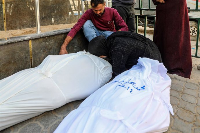 GAZA, April 23, 2026  -- Palestinians mourn over victims who were killed in an Israeli airstrike, at Al-Shifa hospital in Gaza City on April 23, 2026. Five Palestinians, including three children, were killed on Wednesday evening in an Israeli strike on th