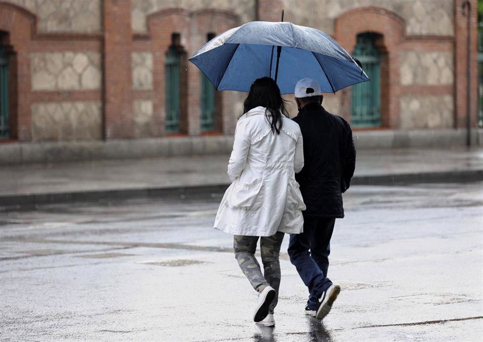 Archivo - Varias personas caminan con paraguas el día en que han puesto en aviso amarillo a la Comunidad de Madrid por tormentas y lluvias, a 2 de mayo de 2022, en Madrid (España). 