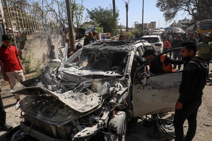 GAZA, April 28, 2026  -- Palestinians inspect a destroyed vehicle after an Israeli airstrike in Gaza City, April 28, 2026. Three Palestinians, including a child, were killed on Tuesday by Israeli fire in Gaza, according to Palestinian sources.