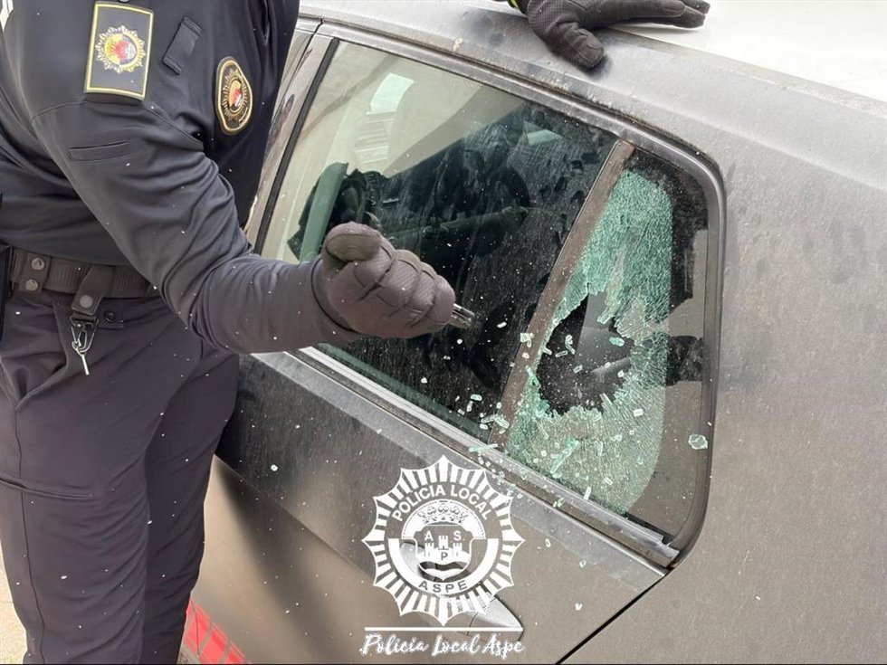 Un agente rompe el cristal del vehículo