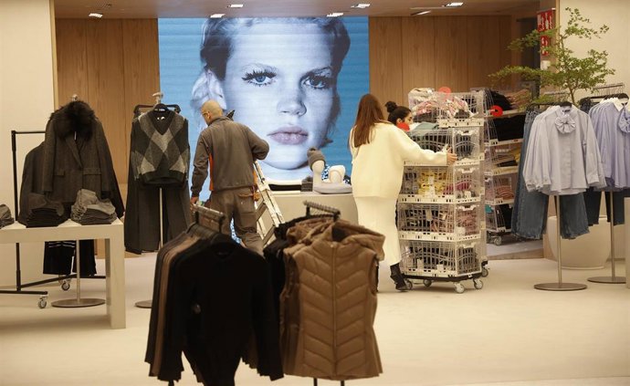 Archivo - Varios trabajadores en una tienda de moda