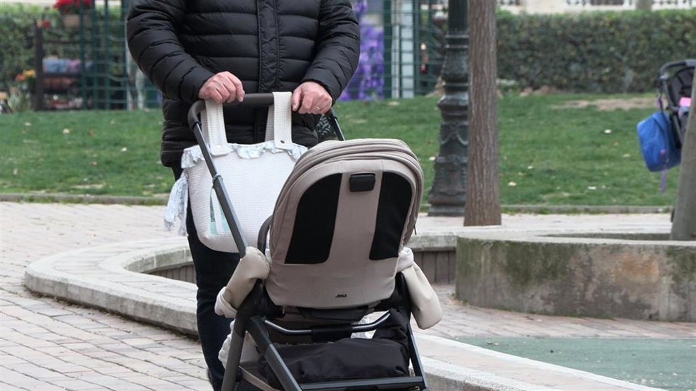 Archivo - Una manos de hombre empujan un carrito de bebé.