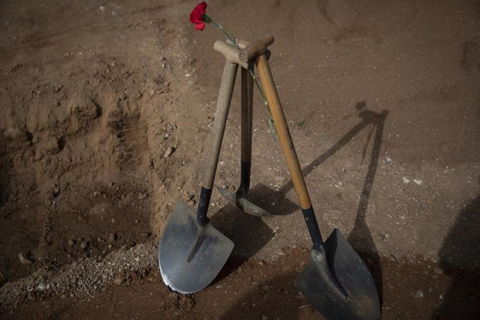 Archivo - Palas y un clavel rojo colocados de forma simbólica en el acto institucional del cierre de la fosa de Pico Reja, en el cementerio de Sevilla, como imagen de recurso.