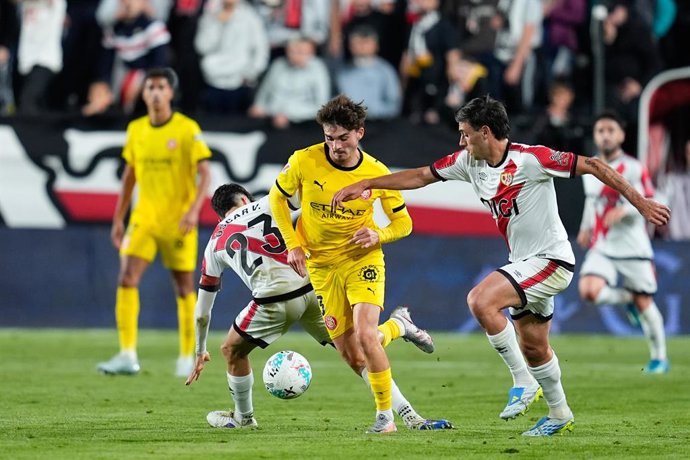 Joel Roca of Girona FC, Pedro Diaz and Oscar Valentin of Rayo Vallecano compete for the ball during the Spanish League, LaLiga EA Sports, football match played between Rayo Vallecano and Girona FC at Estadio de Vallecas on May 11, 2026, in Madrid, Spain.