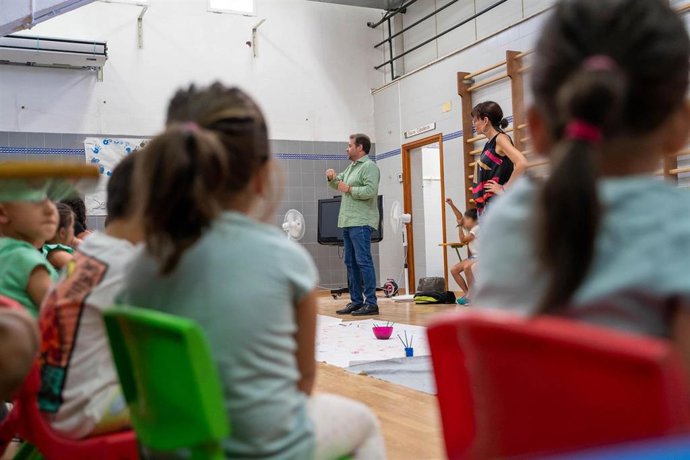 Archivo - Menores participantes en el campus de conciliación verano de la pasada edición, en una visita del alcalde. 