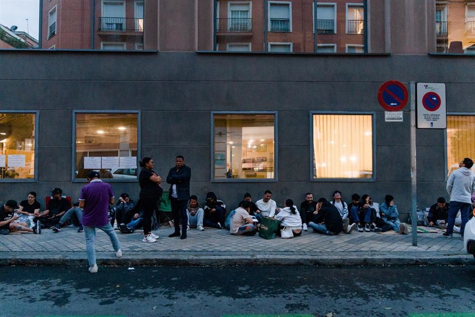 Varias personas hacen cola nocturna para conseguir el certificado de vulnerabilidad en una Oficina de Asistencia en Materia de Registro, a 21 de abril de 2026, en Madrid (España). 