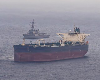 May 8, 2026, Arabian Sea, International Waters: The U.S. Navy Arleigh Burke-class guided-missile destroyer USS Rafael Peralta intercepts the Iranian-flagged oil tanker M/V Herby, enforcing the self-declared maritime blockade against ships entering or exit