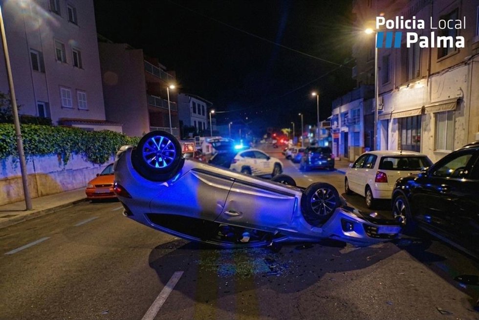 Un conductor ebrio choca contra dos coches aparcados y acaba con su vehículo volcado y cruzado sobre la calle.