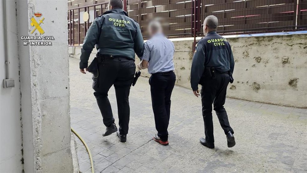 El individuo escoltado por agentes de la Guardia Civil tras su detención.