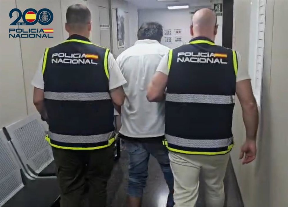 El detenido, escoltado por dos agentes de la Policía Nacional.