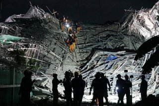 MANILA, May 25, 2026  -- Rescuers search for survivors at the site of a collapsed building in Angeles City, Pampanga province, the Philippines, May 24, 2026. Four people were confirmed dead after a building collapsed before dawn Sunday in Angeles City in 