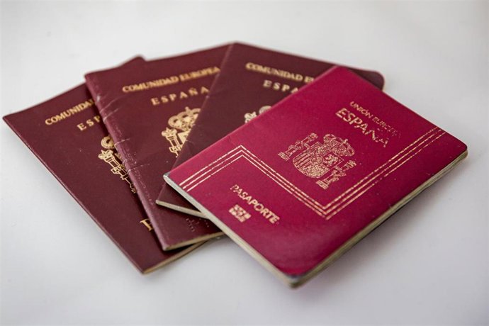Archivo - Varios pasaportes españoles colocados sobre una mesa.