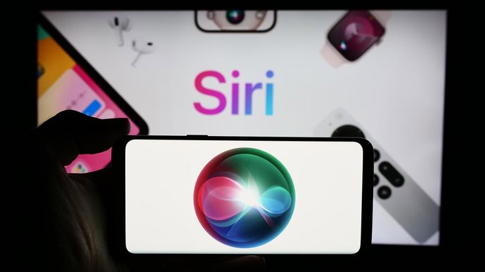 Archivo - January 3, 2025: Stuttgart, Germany - 05-24-2024: Person holding cellphone with logo of digital assistant software Siri (Apple Inc.) in front of business webpage. Focus on phone display. Unmodified photo.
