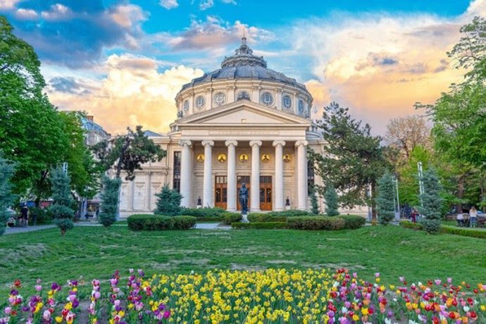 BUCHAREST, ROMANIA - 28.04.2019: Romanian Atheneum, an important concert hall and a landmark in Bucharest, Romania. Sunset colors.