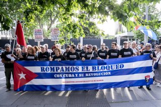 Varias personas con pancarta con lema 'Rompamos el bloqueo. Con Cuba y su revolución' durante la celebración de la vigilia #PetróleoPaCuba por el derecho a la vida, por la soberanía y por la paz, a 5 de junio de 2026, en Madrid (España). Esta movilización