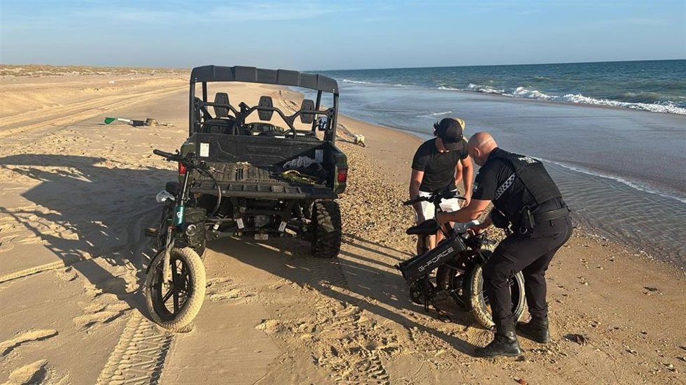 Agentes de la Policía Local de Almonte auxilian a dos jóvenes cuyas bicicletas eléctricas se quedaron sin batería en pleno litoral de Doñana.