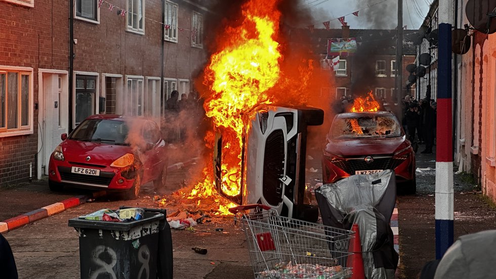 09 June 2026, United Kingdom, Belfast: Vehicles set on fire by protesters on Lendrick Street in Belfast, as disorder flared in response to Monday night's stabbing attack in the city. Photo: -/PA Wire/dpa