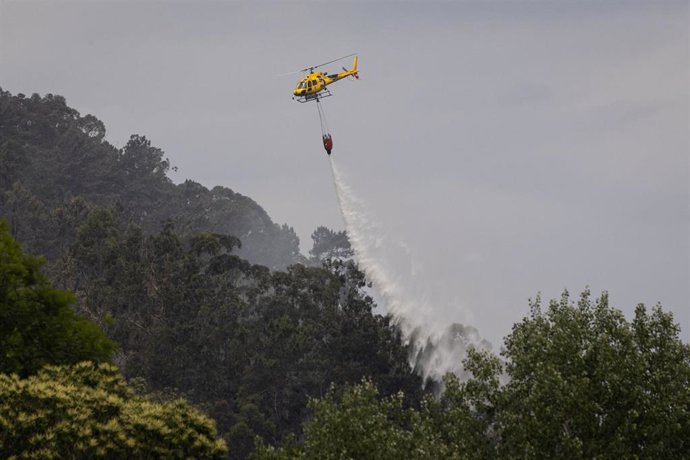 Helicóptero durante las labores de extinción de un incendio forestal, a 14 de junio de 2026, en Grado, Asturias (España). 