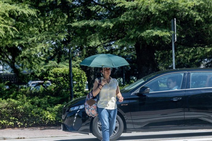 Archivo - Una persona con paraguas, a 27 de junio de 2025, en Madrid (España). La AEMET ha emitido un aviso especial por ola de calor que se extenderá desde el sábado hasta al menos el martes, afectando a gran parte de España. Se esperan temperaturas supe