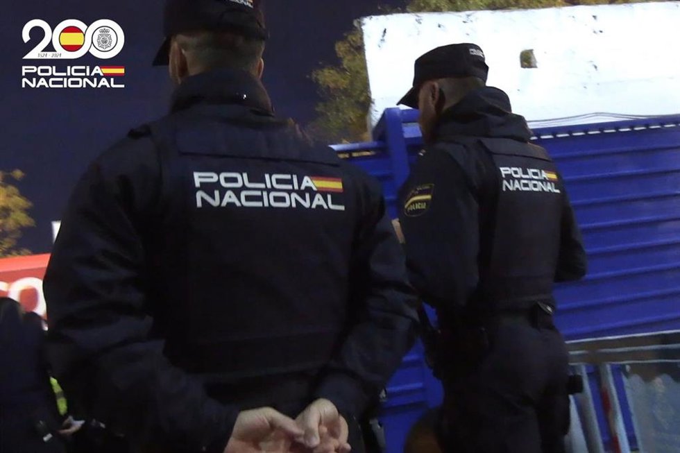 Dos agentes de la Policía Nacional, de espaldas.