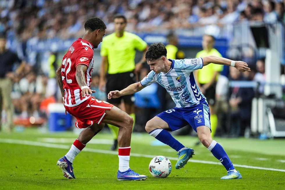 Aaron Ochoa of Malaga CF and Daijiro Chirino of UD Almeria in action during the Liga Hypermotion.