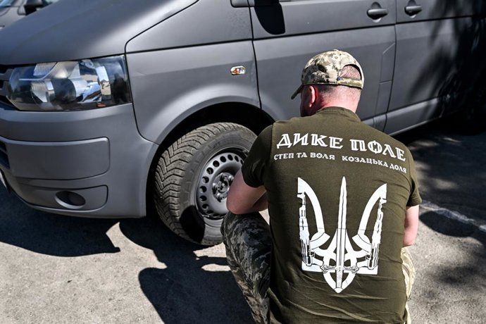 June 16, 2026, Zaporizhzhia Region, Ukraine: A serviceman checks the wheels of a minibus from a batch of 14 vehicles handed over to eight Ukrainian military units operating in the Zaporizhzhia sector, Ukraine, on June 16, 2026. Part of the vehicles will r