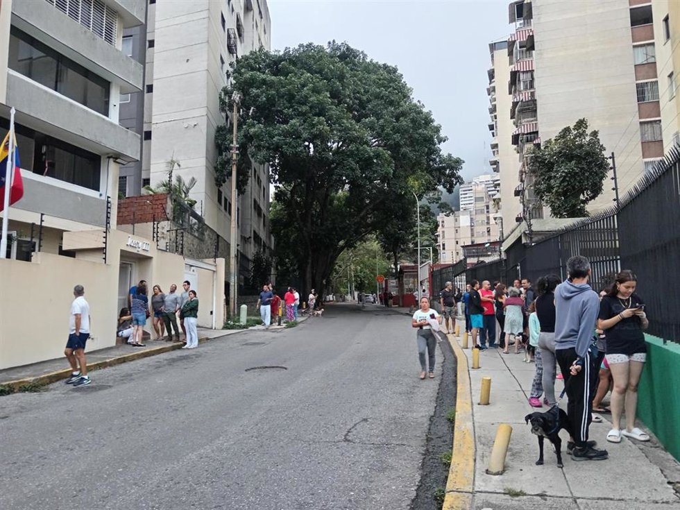 CARACAS, June 25, 2026  -- This photo taken with a mobile phone shows people gathering in an open space after an earthquake in Caracas, Venezuela, June 24, 2026. Two powerful earthquakes struck Venezuela in quick succession on Wednesday evening, both caus
