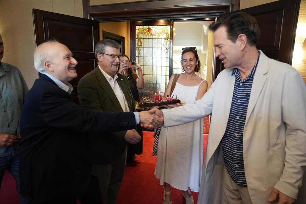 El cantante Chris Isaak (d) es felicitado por Gorka Martínez (izda) y el alcalde de Bilbao por su 70 cumpleaños.