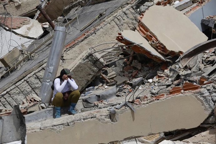 A woman sits on the rubble of a collapsed building in Caraballeda, La Guaira state, Venezuela, June 28, 2026.
