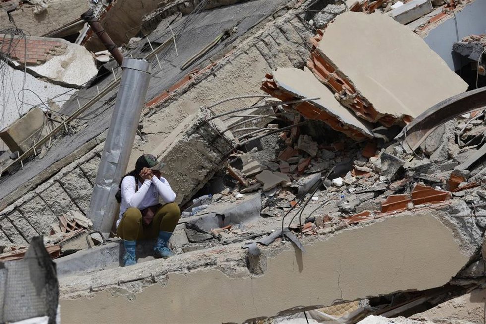 A woman sits on the rubble of a collapsed building in Caraballeda, La Guaira state, Venezuela, June 28, 2026.