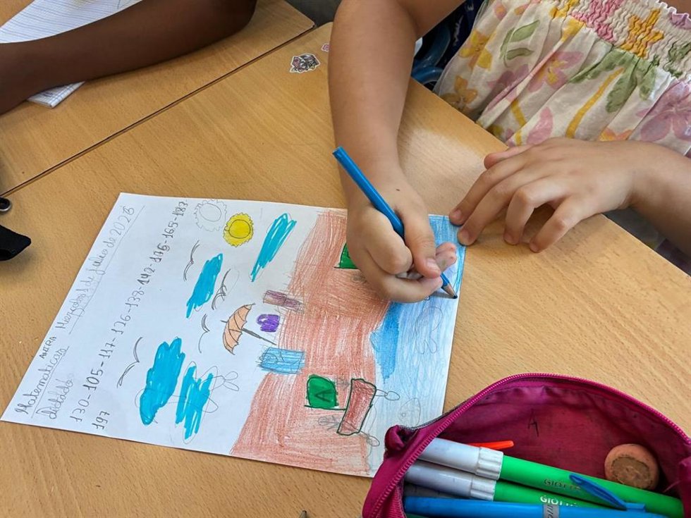 Una escolar del programa de refuerzo estival de la Junta en Almería colorea un dibujo.
