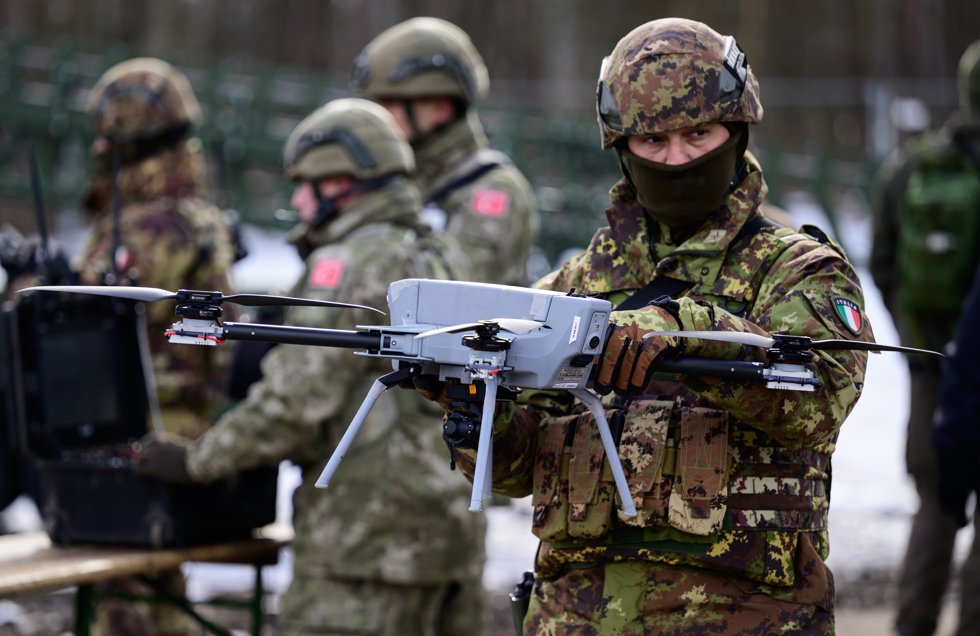 19 February 2026, Lower Saxony, Bergen: An Italian soldier shows off a drone during an exhibition as part of a NATO exercise in Bergen. NATO's largest multinational exercise of the year began on January 15.