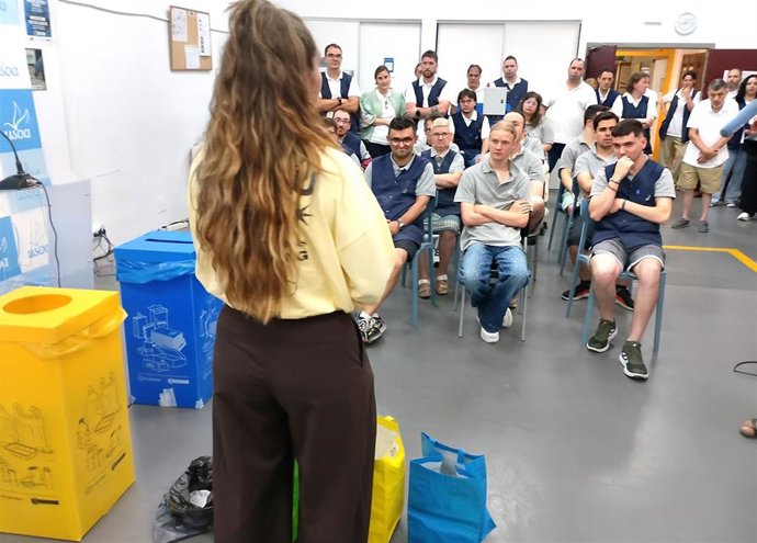 Una monitora explica el correcto recicleja a trabajadores con discapacidad intelectual en el Taller Usoa de Barakaldo