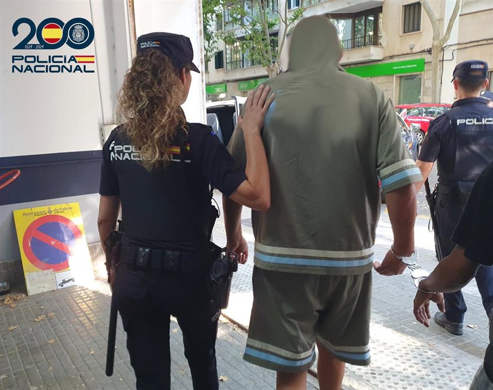 Agentes de la Policía Nacional con el dueño del restaurante detenido.