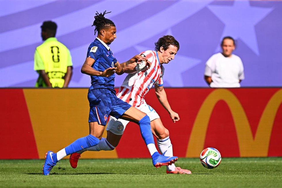 Michael Olise pelea una pelota con Matías Galarza durante el Francia-Paraguay de octavos de final del Mundial 2026
