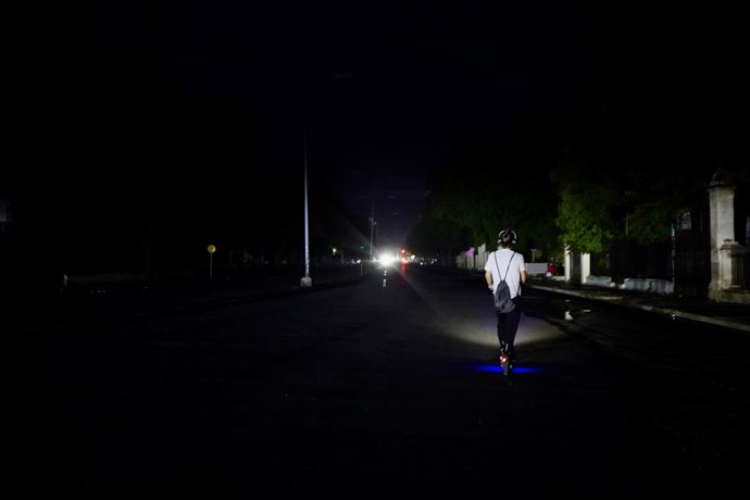 HAVANA, July 11, 2026  -- A man rides an electric scooter on a street during a blackout in Havana, Cuba, July 10, 2026. Cuba was hit by another nationwide blackout on Friday, as the country's power system completely collapsed at 4:30 p.m. local time, acco