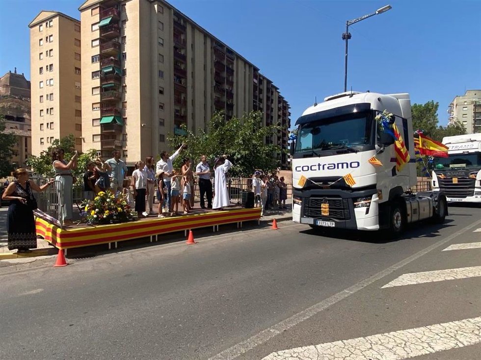 Varios de los camiones pasan junto al escenario de la avenida Lérida en el desfile de San Cristóbal celebrado este sábado en Monzón.