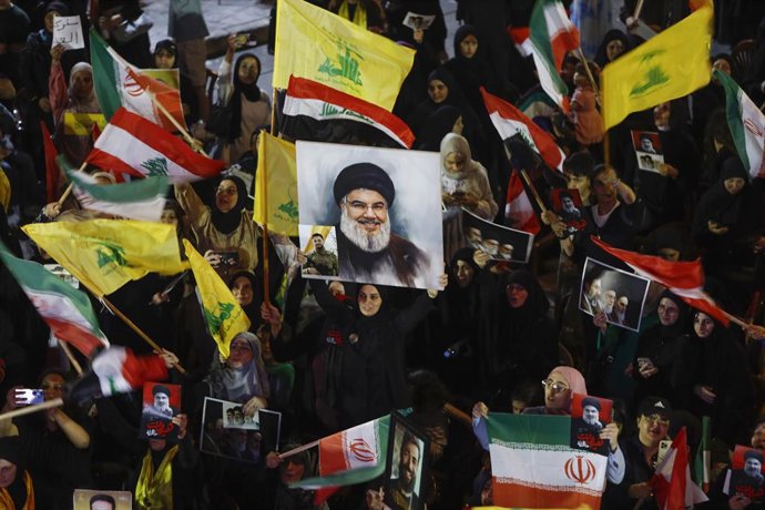 Archivo - Arquivo - 10 de junho de 2026, Beirute, Líbano: Apoiadores do Hezbollah, grupo pró-Irã, agitam bandeiras e exibem fotos do líder do partido assassinado, Nasrallah, durante uma cerimônia no subúrbio sul de Beirute em apoio ao partido e a Teerã em