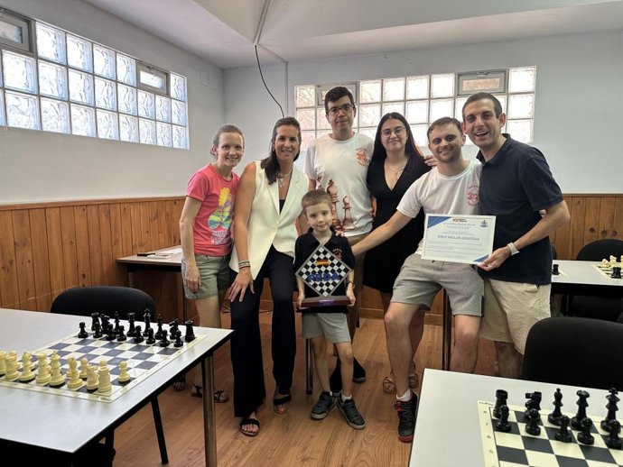La directora general de Deporte, junto a Enzo, sus padres y entrenadores en el Club de Ajedrez Marcos Frechín.