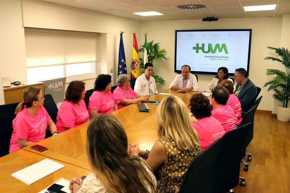 La unidad de Oncología del Hospital  Universitario Virgen Macarena junto a representantes de la Asociación 'Verenia Santa Águeda' de Brenes, quienes han realizado una donación de 10.000 euros para investigación