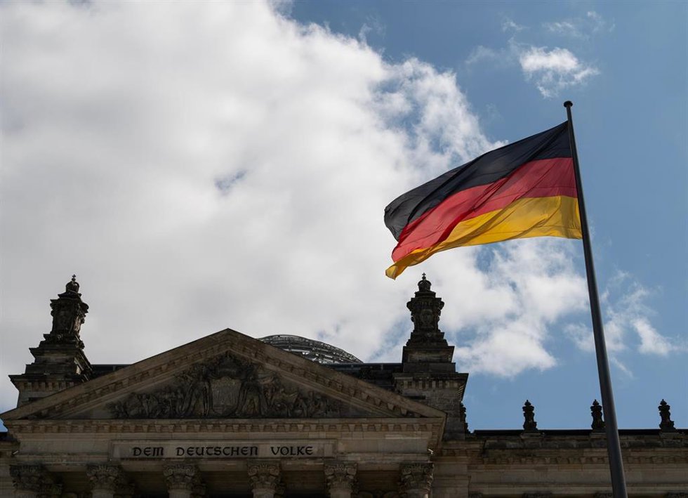 Archivo - Bandera nacional alemana frente al edificio del Reichstag en Berlín, Alemania