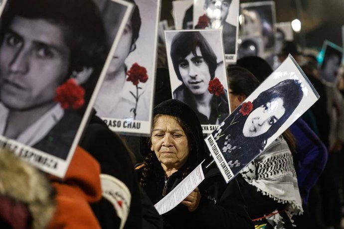 Santiago, 24 de julio de 2026.  Con una cadena de personas unidos a traves de un hilo rojo y con fotografias de Detenidos Desaparecidos, se conmemora mediante una caminata hasta la Catedral a los 119 opositores politicos desaparecidos mediante la