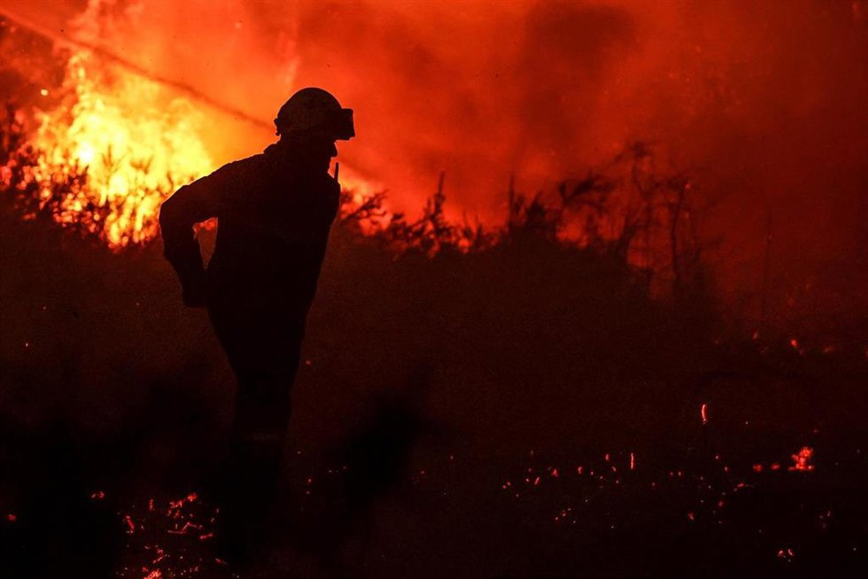 Archivo - Un bombero pasa junto a las llamas de un incendio forestal cerca de Belin-Beliet, en un incendio registrado en 2022.